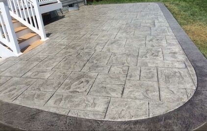 Decorative concrete off of a porch from a house 